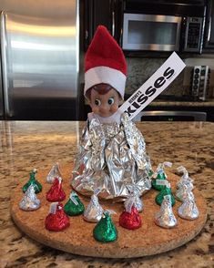 an elf is sitting on top of tin foil