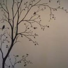 a tree with birds sitting on it in front of a white wall and gray background