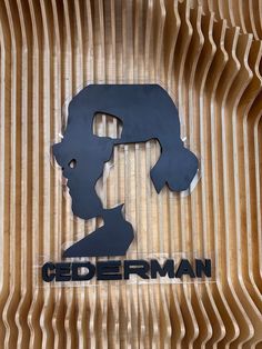 a wooden wall with a sign that says gederman on it and a woman's head