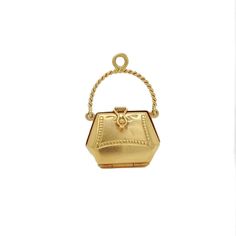 A fine vintage figural purse charm or pendant.  In 18k gold (with a light rose gold hue).  In the form of a purse or lady's handbag that opens with a hinge to the base and a snap closure that closes tightly.  Supported on a rope-twist, swing handle bail  allows this to be worn as a large charm in a charm bracelet or fixed with a jump ring to wear as a pendant necklace.   Marked to the bail with an assay mark.  Simply a wonderful high-level charm!  Date: 20th Century  Overall Condition: It is in overall good, as-pictured, used estate condition with some fine & light surface scratches and other signs of expected light wear consistent with age.  Fineness: Unmarked for gold fineness. Professionally tests at 18k.  Marks: Marked to the top of the bail with an assay mark.  Measurements: Width: ca Elegant Everyday Jewelry With Charms, Evening Yellow Gold Jewelry With Box Clasp, Elegant Compact Locket Jewelry, Elegant Gold-tone Jewelry As Gift, Yellow Gold Jewelry With Gold-tone Hardware For Evening, Compact Yellow Gold Jewelry For Formal Occasions, Elegant Gold Jewelry For Everyday Use, Gold-tone Jewelry With Box Clasp For Gift, Gold Jewelry With Lobster Clasp For Evening