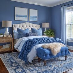 a bedroom with blue walls and white furniture