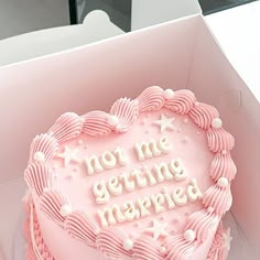 a pink heart shaped cake with white frosting that says, not me getting married