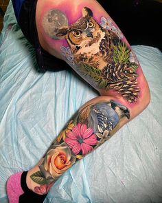 an owl and flower tattoo on the leg