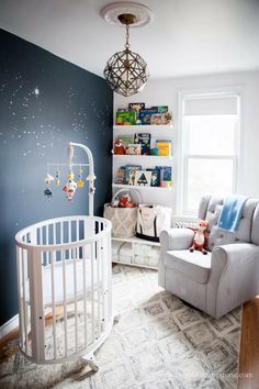 a baby's room is decorated in blue, white and gray with stars on the wall