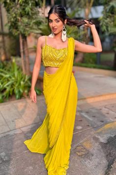 Yellow pre-draped saree crafted in georgette with sequin bloom border and spluttered sequin embellishments. Paired with a synodic sequin-bead swerve embroidered blouse. - Aza Fashions Festive Yellow Pre-draped Saree, Pre-draped Georgette Saree With Pallu, Sleeveless Georgette Saree For Navratri, Yellow Pre-draped Party Saree, Draped Georgette Blouse For Festivals, Festive Draped Blouse Piece In Georgette, Sleeveless Georgette Pre-draped Saree For Navratri, Yellow Pre-draped Saree For Wedding, Georgette Pre-draped Saree With Draped Sleeves For Diwali