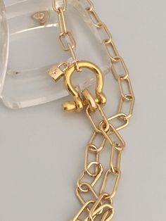 A beautiful shiny gold chain made up of paperclip links. The chain is brass and has several plating coatings of color to give the gold electroplated finish. It is a high quality choker chain. The shackle clasp gives the necklace a modern and unusual edge. It is Gold Plated. Size 21 x 25 mm To finish off this necklace I added a small CZ padlock with a CZ bail. The padlock also features a CZ star. For anyone that has difficulty with necklace closings this one is a breeze! If you look at the pictur