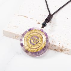 This Orgone Energy Om Amethyst Necklace Talisman is a powerful combination of Amethyst crystal and orgone energy. It's an orgone pendant and amethyst necklace in one stunning jewelry piece that will make you feel high spiritual vibrations. It is specially crafted with high-quality materials and has one of the most striking looks for an orgone amethyst stone pendant! Amethyst Crystal Healing Necklace With Round Pendant, Amethyst Amulet Necklace For Meditation, Spiritual Amethyst Round Pendant Necklace, Spiritual Purple Round Pendant Necklace, Spiritual Amethyst Crystal Necklace, Spiritual Round Amethyst Crystal Necklace, Purple Crystal Healing Necklace, Purple Round Crystal Healing Necklace, Design Tech