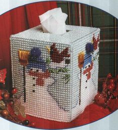 a cross stitch tissue box with snowmen on it