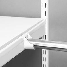 a close up of a white shelf with a metal bar on the top and bottom