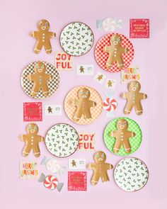 gingerbread cutouts on pink background surrounded by christmas themed paper plates and candy canes