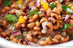 a white bowl filled with beans and cilantro