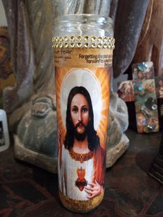 there is a glass jar with the image of jesus on it