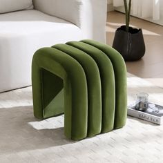 a green bench sitting on top of a white rug