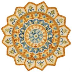 an orange and blue circular rug with leaves on it's center, in the shape of a flower