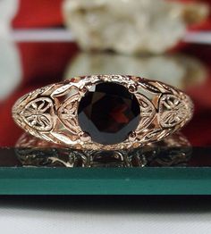 "Natural Red Garnet Ring Description Etched Wedding Design#160 Made To Order Here we have a Victorian/Edwardian reproduction ring in sterling silver with rose gold overlay, \"rose gold embraced\" with a stunning natural red garnet gemstone. This full cut round cut .76ct genuine garnet is 6mm in diameter. The inside of the band is marked 925 for sterling. Notice the beautiful floral design of the silver and gold filigree setting and band. This is a lovely rendition of an Antique filigree ring, an Red Wedding Ring With Intricate Design, Rose Gold Wedding Jewelry With Accent Stones, Rose Gold Jewelry With Accent Stones For Wedding, Heirloom Red Jewelry For Wedding, Red Heirloom Jewelry For Wedding, Antique Round Band Jewelry For Wedding, Antique Jewelry With Round Band For Wedding, Red Round Band For Wedding, Rose Gold Wedding Jewelry With Center Stone