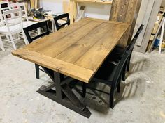 a wooden table with black chairs around it