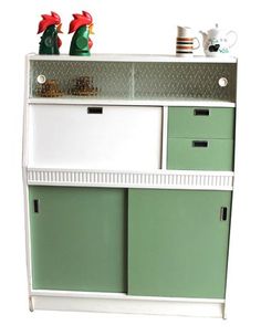 a green and white cabinet with drawers on top