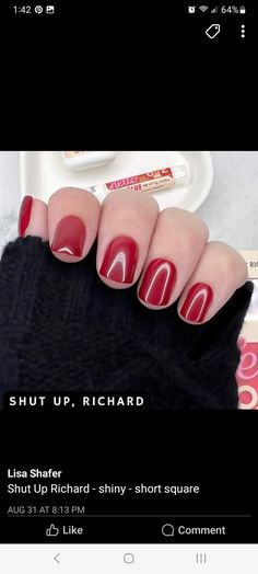 a woman's hand with red nail polish on it