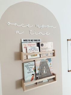 there is a shelf with books on it and a sign that says once upon a time