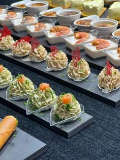 there are many different types of food on the buffet table, including salads and rolls