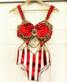 a red and white striped bathing suit hanging on a door