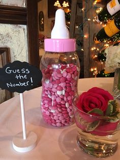 there is a glass bottle with candy in it and a sign that says guess the number