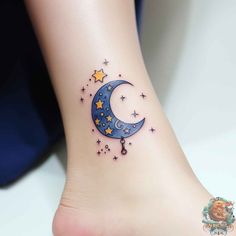 a small moon and stars tattoo on the ankle is shown in this image, it looks like