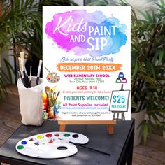 an easel with paint and brushes on it next to a sign that says kids paint and sip