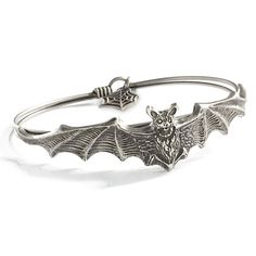 Adorn your wrist with a glamorous touch of gothic style with our Bat Bangle Bracelet. Crafted from non-toxic alloy metal, this bangle bracelet is available in antique bronze or silver finishes for a sophisticated look. Securely fasten the bracelet with the hook-and-loop closure and celebrate the beauty of bats with this stylish accessory. Summon Creatures, Bat Bracelet, Steampunk Outfits, Vampire Bats, Vampire Jewelry, Bat Jewelry, Gothic Bracelet, Halloween Bracelet, Style Gothic