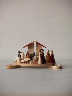 a wooden nativity scene with figurines in it