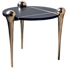 a black and gold table with two balls on the top, sitting in front of a white background