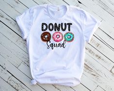 a t - shirt that says donut squad on it with two doughnuts