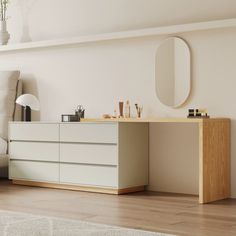 a white couch sitting next to a dresser in a living room