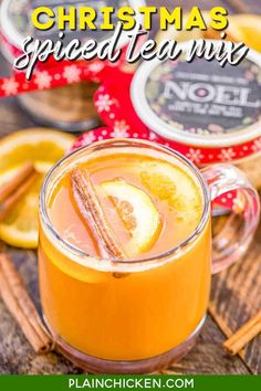 christmas spiced tea mix in a glass mug with cinnamon sticks and orange slices on the side