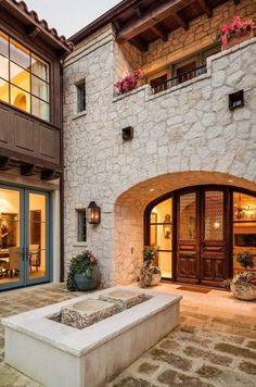 an outside view of a house with stone walls and doors