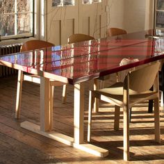 a dining room table with chairs and a radiator on the wall next to it