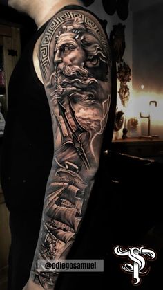 a man with a black and grey tattoo on his arm that has an image of the god