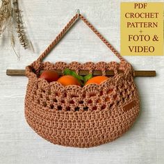 a crocheted bag hanging on a wall with oranges in it and the text, free pattern + foto & video