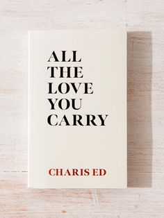 all the love you carry by charles ed book on wooden table with white background and red lettering