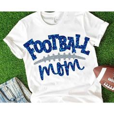 a football mom t - shirt with the words football mom on it next to a football