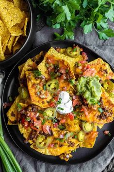 nachos with guacamole, sour cream and tortilla chips