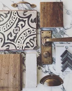 the marble counter top is covered with wood and other decorative items, such as tile