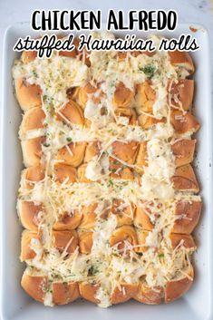 chicken alfredo stuffed hawaiian rolls in a white casserole dish with cheese on top