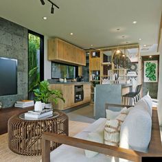 a living room filled with furniture and a flat screen tv on top of a wooden table