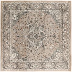 an antique style rug in beige and grey tones with a medallion design on the center