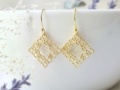 These dainty, filigree earrings, have an elegant floral design. They will compliment a variety of attire, and are lightweight, making them great for everyday wear!  Product details: * Gold plated ear wires; Lead and nickel free * 18k gold plated filigree charm  - Length: 1.25 inches - Width:  .75 inches ❤ You can click here to see more unique jewelry from Flutterbird: https://www.etsy.com/shop/FlutterbirdCo My goal is to provide every customer with exceptional service. Please message me if you h Dainty Pierced Bridal Earrings, Handmade Gold Earrings For Bridesmaid Gift, Delicate Handmade Earrings For Bridesmaids, Handmade Gold Earrings For Bridesmaids, Delicate Brass Wedding Earrings, Elegant Brass Flower Earrings Nickel Free, Elegant Brass Flower Earrings As Gift, Delicate Drop Flower Earrings As Gift For Her, Delicate Drop Flower Earrings For Her