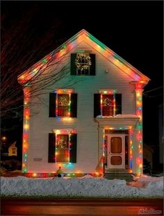 a white house with christmas lights on the windows