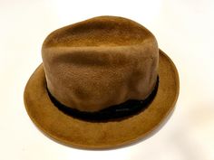 Tan felt hat with a brown braided band. Vintage 1960's era when men wore hats and looked good doing it! Size 7 1/8. The Sovereign by Stetson. Vintage Fur Felt Hat For Fall, Brown Brimmed Felt Hat For Formal Occasions, Vintage Brown Fur Felt Hat, Vintage Brown Fedora For Formal Occasions, Vintage Hat Bands For Fall, Western Brown Flat Cap, Vintage Brown Formal Hat, Brown Vintage Flat Brim Hat, Brown Fedora Felt Hat For Formal Occasions