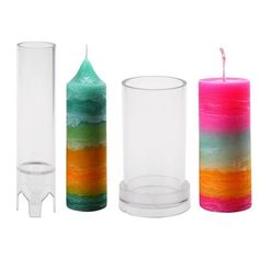 three different colored candles sitting next to each other