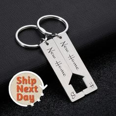 a keychain that says ship next day with an orange and white sticker on it